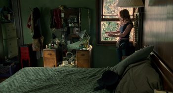 Movie still from “Thirteen” (2003), directed by Catherine Hardwicke – A woman standing in front of a window in a bedroom; Wide shot, High angle
