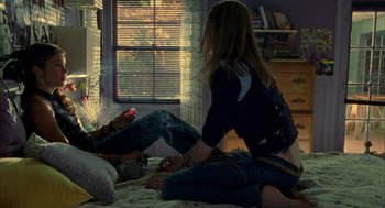 Movie still from “Thirteen” (2003), directed by Catherine Hardwicke – Two people sitting on the floor in front of a window; Medium shot, Overhead angle