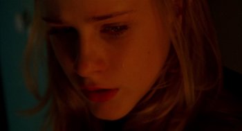 Movie still from “Thirteen” (2003), directed by Catherine Hardwicke – A woman's face in a dimly - lit room; Extreme Close Up shot, Overhead angle