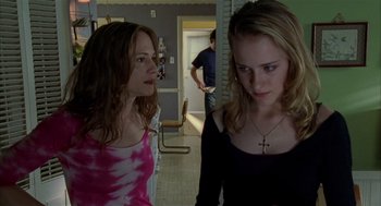 Movie still from “Thirteen” (2003), directed by Catherine Hardwicke – Two young women standing next to each other in a room; Medium shot, Over the shoulder angle