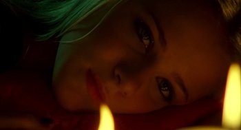 Movie still from “Thirteen” (2003), directed by Catherine Hardwicke – A girl's face with a candle in the background; Extreme Close Up shot, Overhead angle