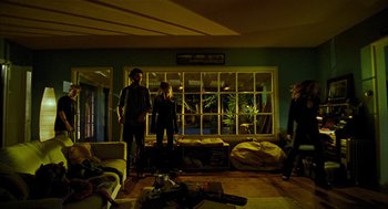 Movie still from “Thirteen” (2003), directed by Catherine Hardwicke – A group of people standing in front of a window; Wide shot, Low angle