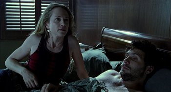 Movie still from “Thirteen” (2003), directed by Catherine Hardwicke – A man and a woman in a bed; Medium shot, Low angle