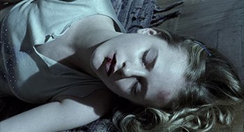 Movie still from “Thirteen” (2003), directed by Catherine Hardwicke – A young woman is laying on the ground with her eyes closed; Close Up shot, Overhead angle