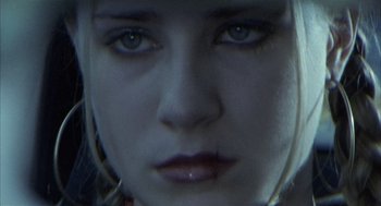 Movie still from “Thirteen” (2003), directed by Catherine Hardwicke – A woman's face with blue eyes; Extreme Close Up shot, Low angle