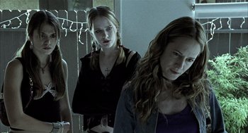 Movie still from “Thirteen” (2003), directed by Catherine Hardwicke – A group of young women standing next to each other in a room; Medium shot, Low angle