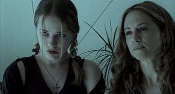 Movie still from “Thirteen” (2003), directed by Catherine Hardwicke – Two young women sitting next to each other in a room; Close Up shot, Low angle