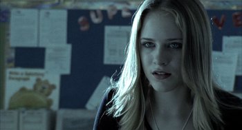 Movie still from “Thirteen” (2003), directed by Catherine Hardwicke – A woman with blonde hair and blue eyes looking at the camera; Close Up shot, Over the shoulder angle