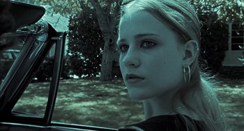 Movie still from “Thirteen” (2003), directed by Catherine Hardwicke – A woman sitting in the driver's seat of a car looking out the window; Close Up shot, Low angle