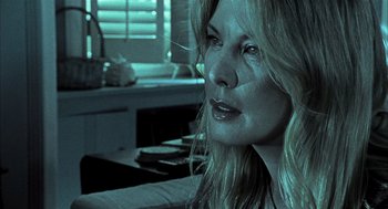 Movie still from “Thirteen” (2003), directed by Catherine Hardwicke – A woman with long blonde hair stares into the distance; Close Up shot, Low angle