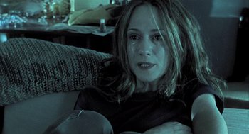 Movie still from “Thirteen” (2003), directed by Catherine Hardwicke – A person sitting on a couch; Close Up shot, High angle