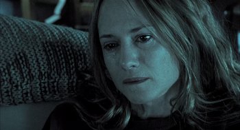 Movie still from “Thirteen” (2003), directed by Catherine Hardwicke – A person crying on a couch; Close Up shot, High angle