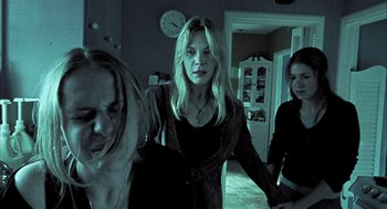 Movie still from “Thirteen” (2003), directed by Catherine Hardwicke – A group of people standing in a room; Medium shot, Low angle
