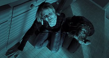 Movie still from “Thirteen” (2003), directed by Catherine Hardwicke – A woman sitting on the floor next to a skateboard; Medium shot, Overhead angle