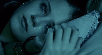 Movie still from “Thirteen” (2003), directed by Catherine Hardwicke – A woman laying on the ground with her hand on her face; Close Up shot, Overhead angle