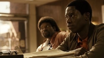 Movie still from “Snowfall” (2017), directed by Hiro Murai – Two men sitting at a table with papers in front of them; Close Up shot, Over the shoulder angle