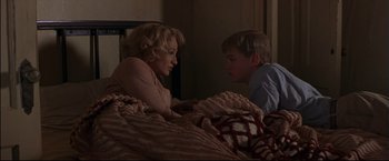 Movie still from “This Boy's Life” (1993), directed by Michael Caton-Jones – A woman and a young boy in a bed; Medium shot, Over the shoulder angle