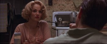 Movie still from “This Boy's Life” (1993), directed by Michael Caton-Jones – A woman sitting in front of an oven in a kitchen; Close Up shot, Over the shoulder angle