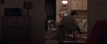 Movie still from “This Boy's Life” (1993), directed by Michael Caton-Jones – A woman sitting at a dinner table with a man; Wide shot, Over the shoulder angle