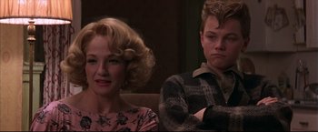 Movie still from “This Boy's Life” (1993), directed by Michael Caton-Jones – A woman and a man sitting next to each other on a couch; Close Up shot, Over the shoulder angle