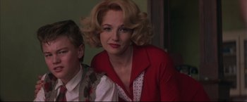 Movie still from “This Boy's Life” (1993), directed by Michael Caton-Jones – A woman with blonde hair and a polka dot blouse; Close Up shot, Low angle