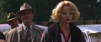 Movie still from “This Boy's Life” (1993), directed by Michael Caton-Jones – A woman with blonde curly hair wearing a polka dot shirt; Close Up shot, Over the shoulder angle