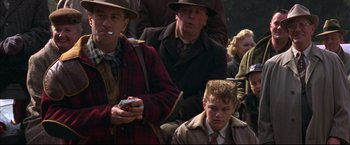 Movie still from “This Boy's Life” (1993), directed by Michael Caton-Jones – A group of people sitting in a crowd; Medium shot, Over the shoulder angle