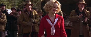 Movie still from “This Boy's Life” (1993), directed by Michael Caton-Jones – A woman in a red dress and a polka dot tie; Medium shot, Over the shoulder angle