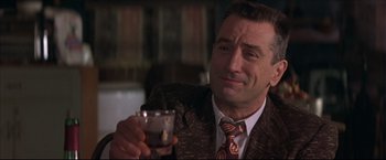 Movie still from “This Boy's Life” (1993), directed by Michael Caton-Jones – A man that is holding a glass in his hand; Close Up shot, Low angle