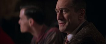 Movie still from “This Boy's Life” (1993), directed by Michael Caton-Jones – A person wearing a suit and tie; Close Up shot, Over the shoulder angle