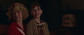 Movie still from “This Boy's Life” (1993), directed by Michael Caton-Jones – A young girl wearing glasses and a sweater; Close Up shot, Low angle