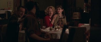 Movie still from “This Boy's Life” (1993), directed by Michael Caton-Jones – Two people sitting at a table with candles; Medium shot, Over the shoulder angle