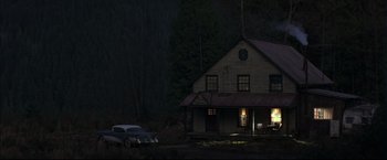 Movie still from “This Boy's Life” (1993), directed by Michael Caton-Jones – A car parked in front of a house at night; Extreme Wide shot, High angle