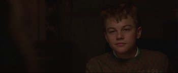 Movie still from “This Boy's Life” (1993), directed by Michael Caton-Jones – A young man is sitting in a dark room; Close Up shot, Over the shoulder angle