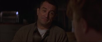 Movie still from “This Boy's Life” (1993), directed by Michael Caton-Jones – A person sitting down with his eyes wide open; Close Up shot, Over the shoulder angle