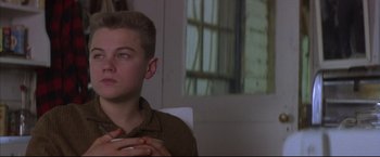 Movie still from “This Boy's Life” (1993), directed by Michael Caton-Jones – A young man sitting in front of an open window; Close Up shot, Low angle
