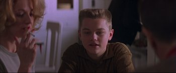 Movie still from “This Boy's Life” (1993), directed by Michael Caton-Jones – A young boy sitting in front of a wall; Close Up shot, Low angle