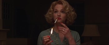 Movie still from “This Boy's Life” (1993), directed by Michael Caton-Jones – A woman holding a lit cigarette in her mouth; Close Up shot, Low angle