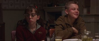 Movie still from “This Boy's Life” (1993), directed by Michael Caton-Jones – A man and a woman sitting at a dinner table; Medium shot, Over the shoulder angle