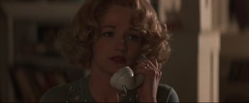 Movie still from “This Boy's Life” (1993), directed by Michael Caton-Jones – A woman talking on a phone while wearing a ring; Close Up shot, High angle