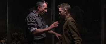 Movie still from “This Boy's Life” (1993), directed by Michael Caton-Jones – A man and a young boy talking to each other; Medium shot, Over the shoulder angle