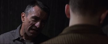 Movie still from “This Boy's Life” (1993), directed by Michael Caton-Jones – A man talking to another man who is looking at him; Close Up shot, Over the shoulder angle