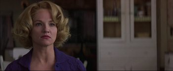 Movie still from “This Boy's Life” (1993), directed by Michael Caton-Jones – A woman with blonde curly hair wearing a purple sweater; Close Up shot, Over the shoulder angle
