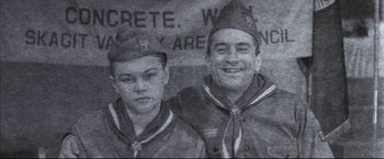 Movie still from “This Boy's Life” (1993), directed by Michael Caton-Jones – Two young men in uniforms are posing for a picture; Close Up shot, Low angle