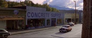 Movie still from “This Boy's Life” (1993), directed by Michael Caton-Jones – A concrete supply store on the side of the street; Extreme Wide shot, High angle