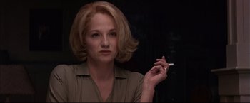 Movie still from “This Boy's Life” (1993), directed by Michael Caton-Jones – A woman holding a cigarette in her right hand; Close Up shot, Over the shoulder angle