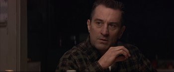 Movie still from “This Boy's Life” (1993), directed by Michael Caton-Jones – A person wearing a plaid shirt; Close Up shot, Over the shoulder angle