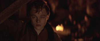 Movie still from “This Boy's Life” (1993), directed by Michael Caton-Jones – A young man in a red jacket is looking at the camera; Close Up shot, Low angle