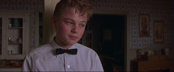 Movie still from “This Boy's Life” (1993), directed by Michael Caton-Jones – A young man wearing a bow tie in a room; Close Up shot, Low angle