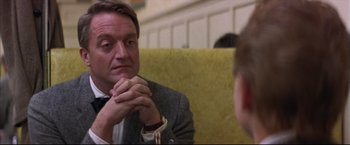 Movie still from “This Boy's Life” (1993), directed by Michael Caton-Jones – A man sitting in front of another man in a suit; Close Up shot, Over the shoulder angle